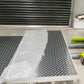 5052 Alloy Aluminium Checker Plate stored in a warehouse, showcasing its protective packaging and highlighting the detailed checkered design.